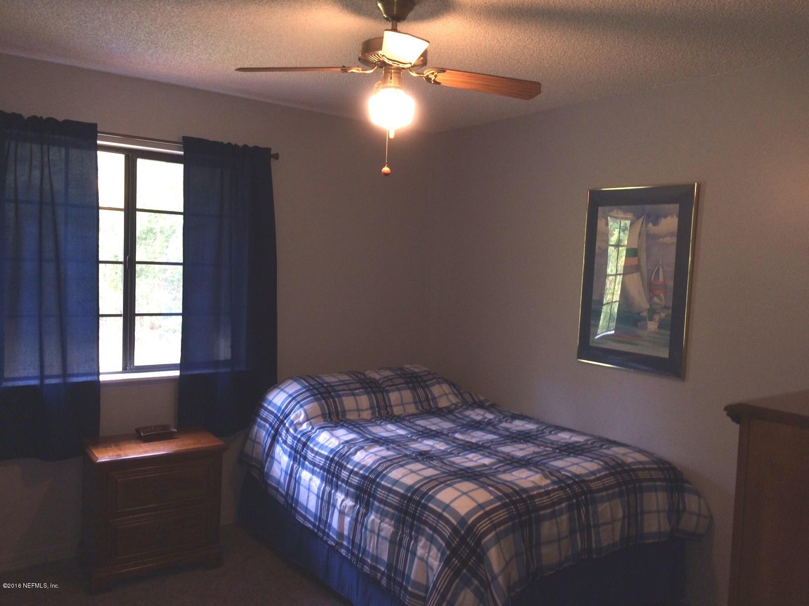 1112 Cactus Cut Road Middleburg, FL 32068 - Photo 25 of 48 a bedroom with a bed and window