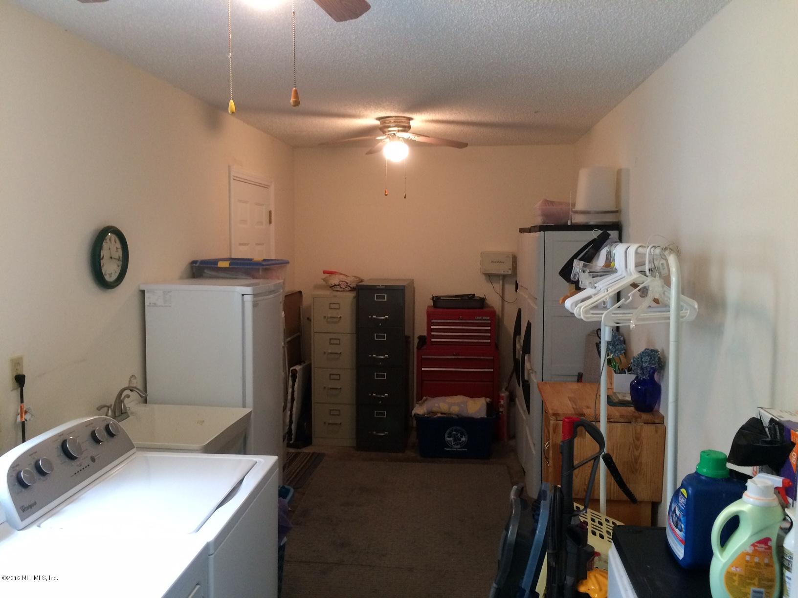 1112 Cactus Cut Road Middleburg, FL 32068 - Photo 27 of 48 a view of a room with gym equipment