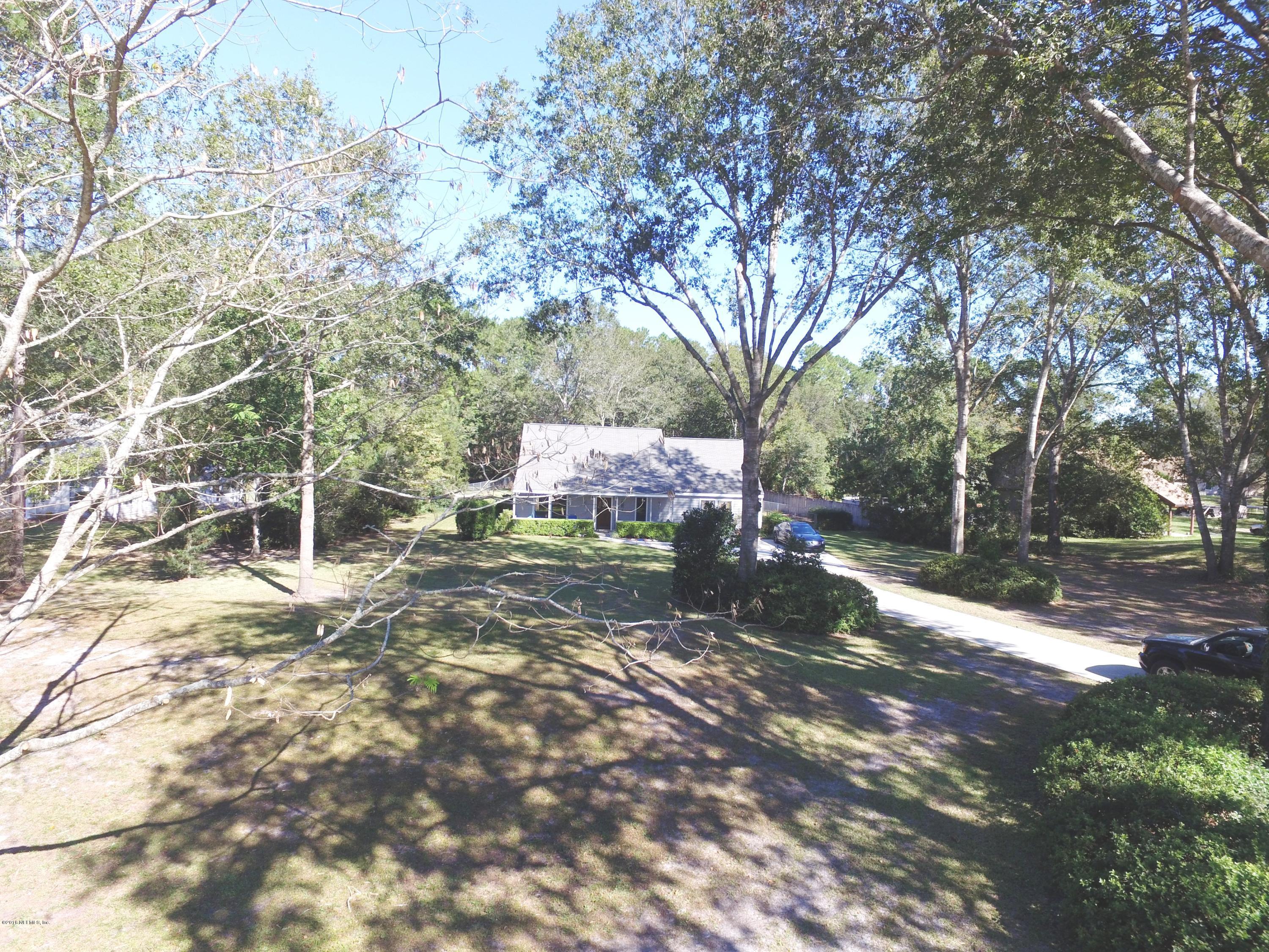 1112 Cactus Cut Road Middleburg, FL 32068 - Photo 3 of 48 a backyard of a house with table and chairs