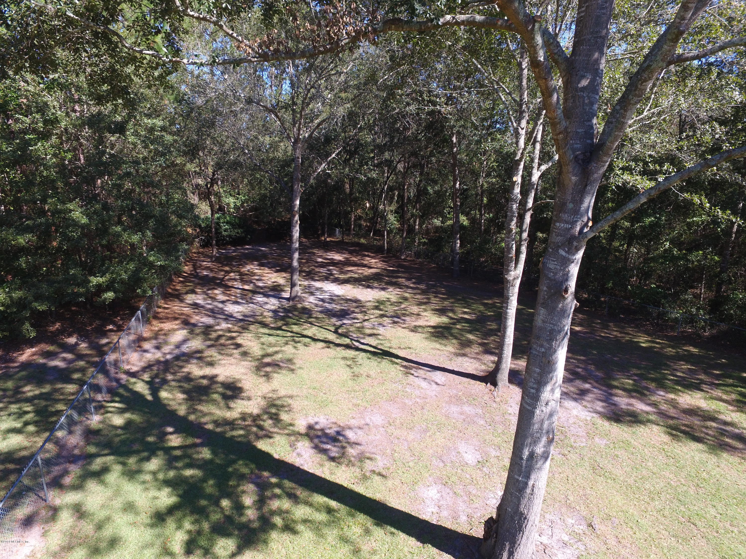 1112 Cactus Cut Road Middleburg, FL 32068 - Photo 31 of 48 a view of a yard with wooden fence