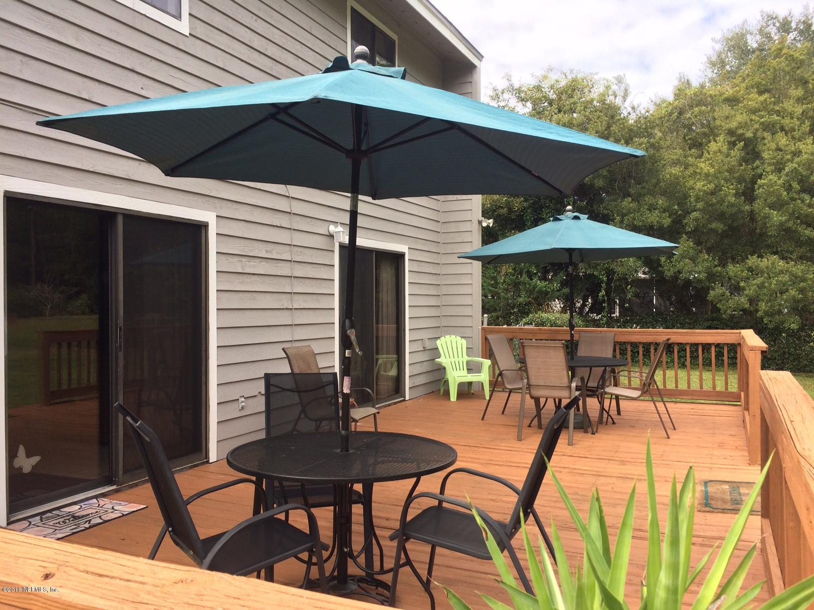 1112 Cactus Cut Road Middleburg, FL 32068 - Photo 7 of 48 a view of a patio with furniture and table under an umbrella