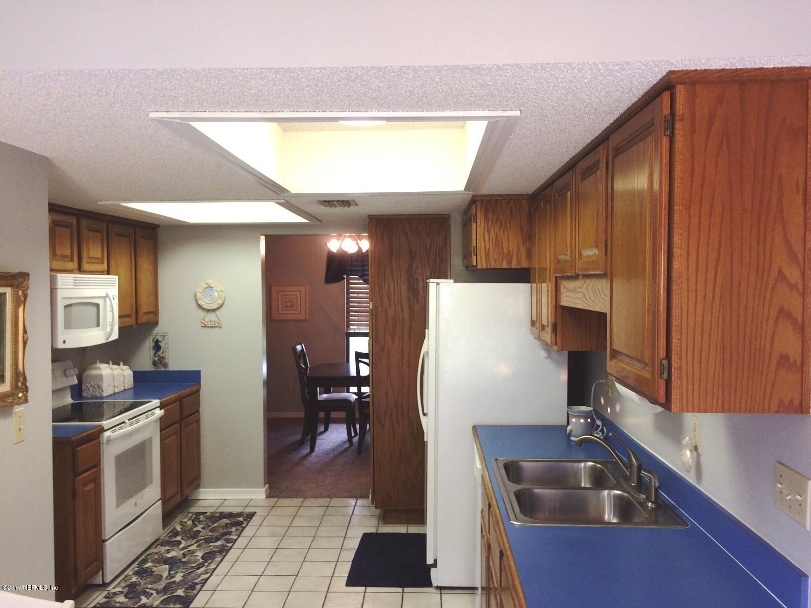 1112 Cactus Cut Road Middleburg, FL 32068 - Photo 9 of 48 a kitchen with a sink a refrigerator and cabinets