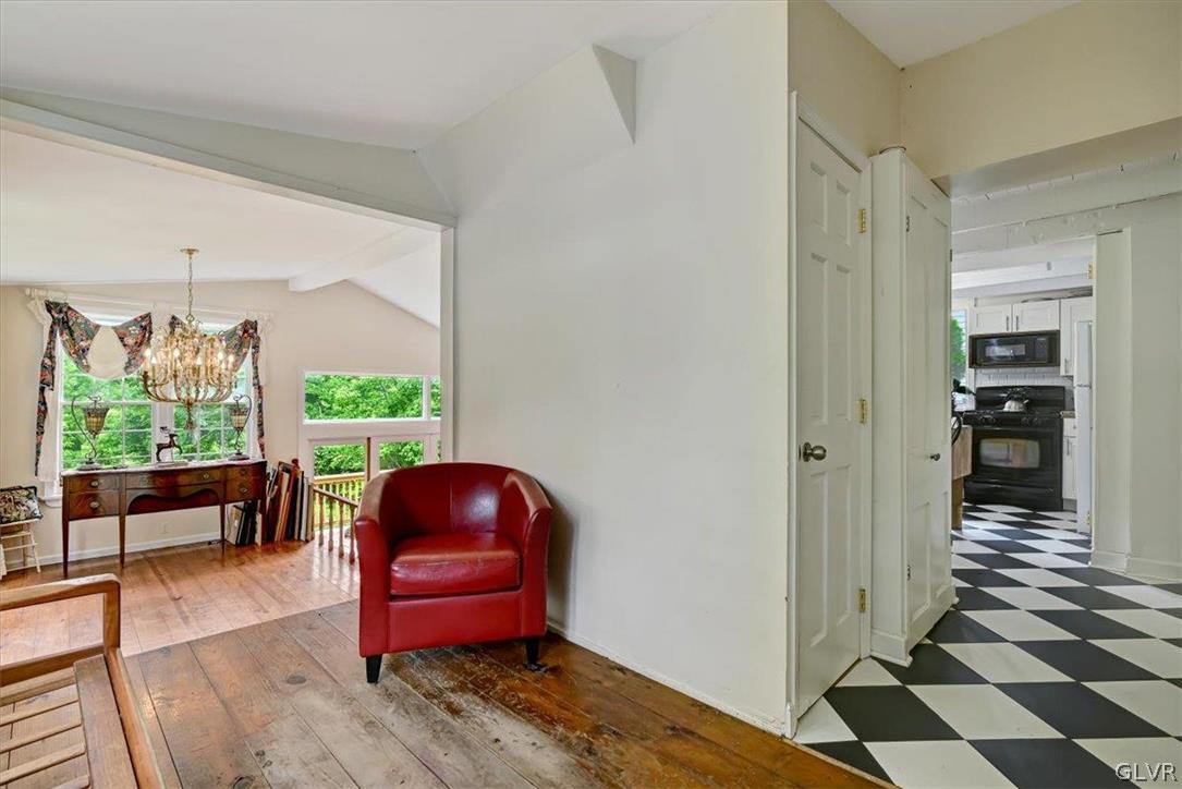 4825 River Road New Hope, PA 18938 - Photo 8 of 50 a hallway with a couch and a floor to ceiling window