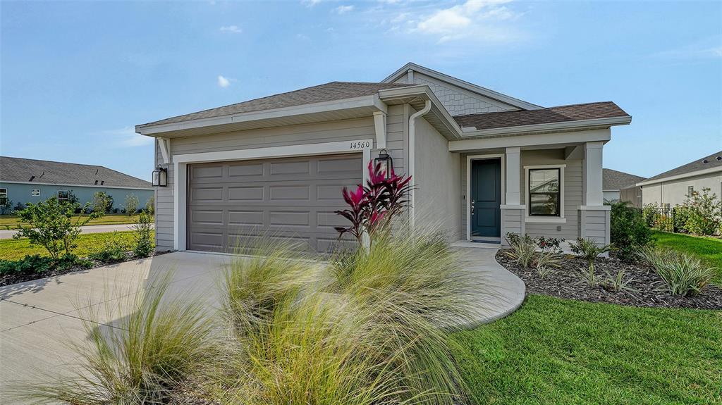 14560 Skipping Stone Loop Parrish, FL 34219 - Photo 1 of 27 a front view of house with yard