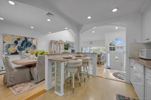a kitchen with stainless steel appliances kitchen island granite countertop a sink and cabinets