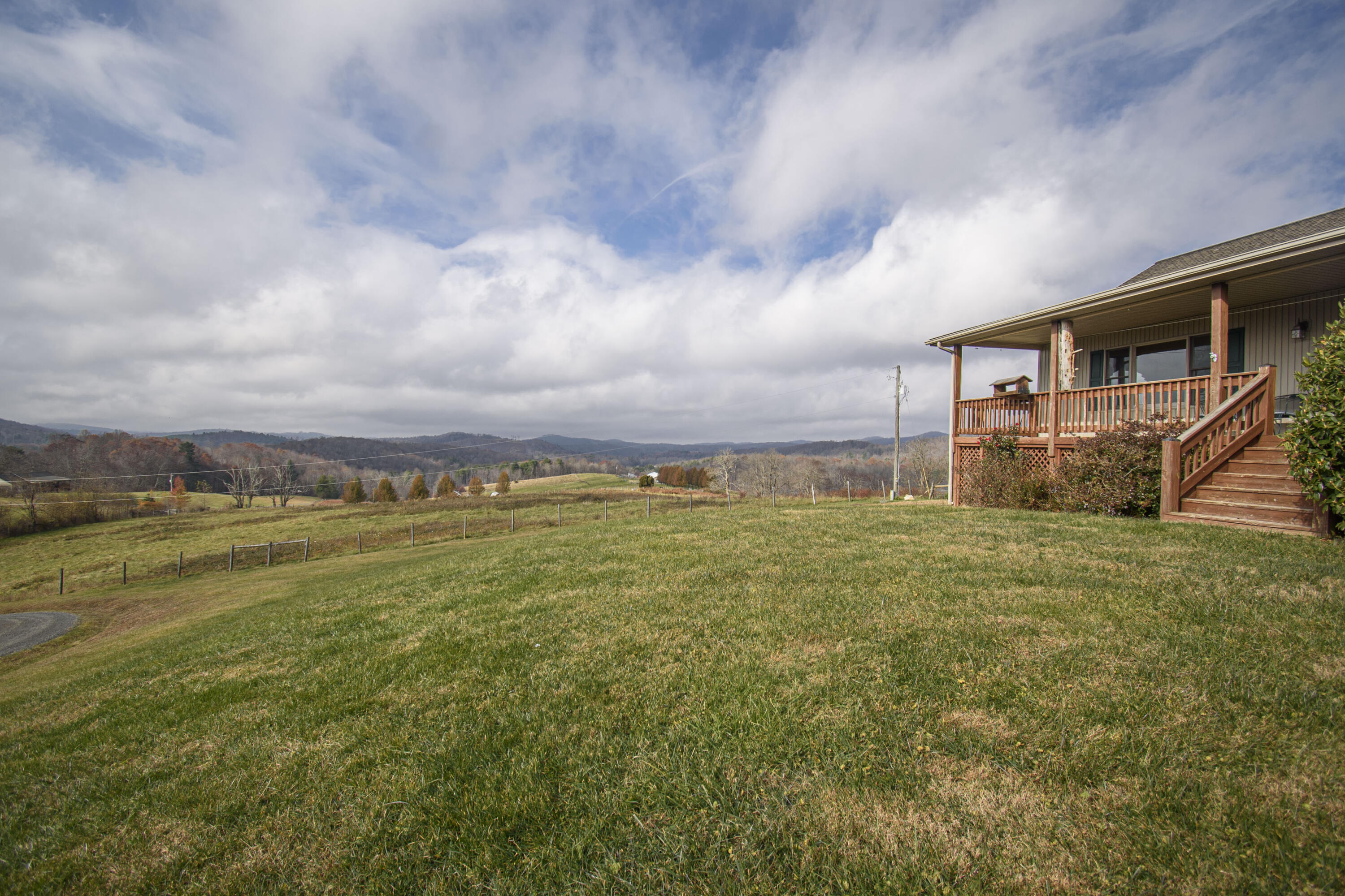 5485 Buffalo Mountain Road Southwest Willis, VA 24380 - Photo 14 of 77 a view of a big house with a big yard and large trees