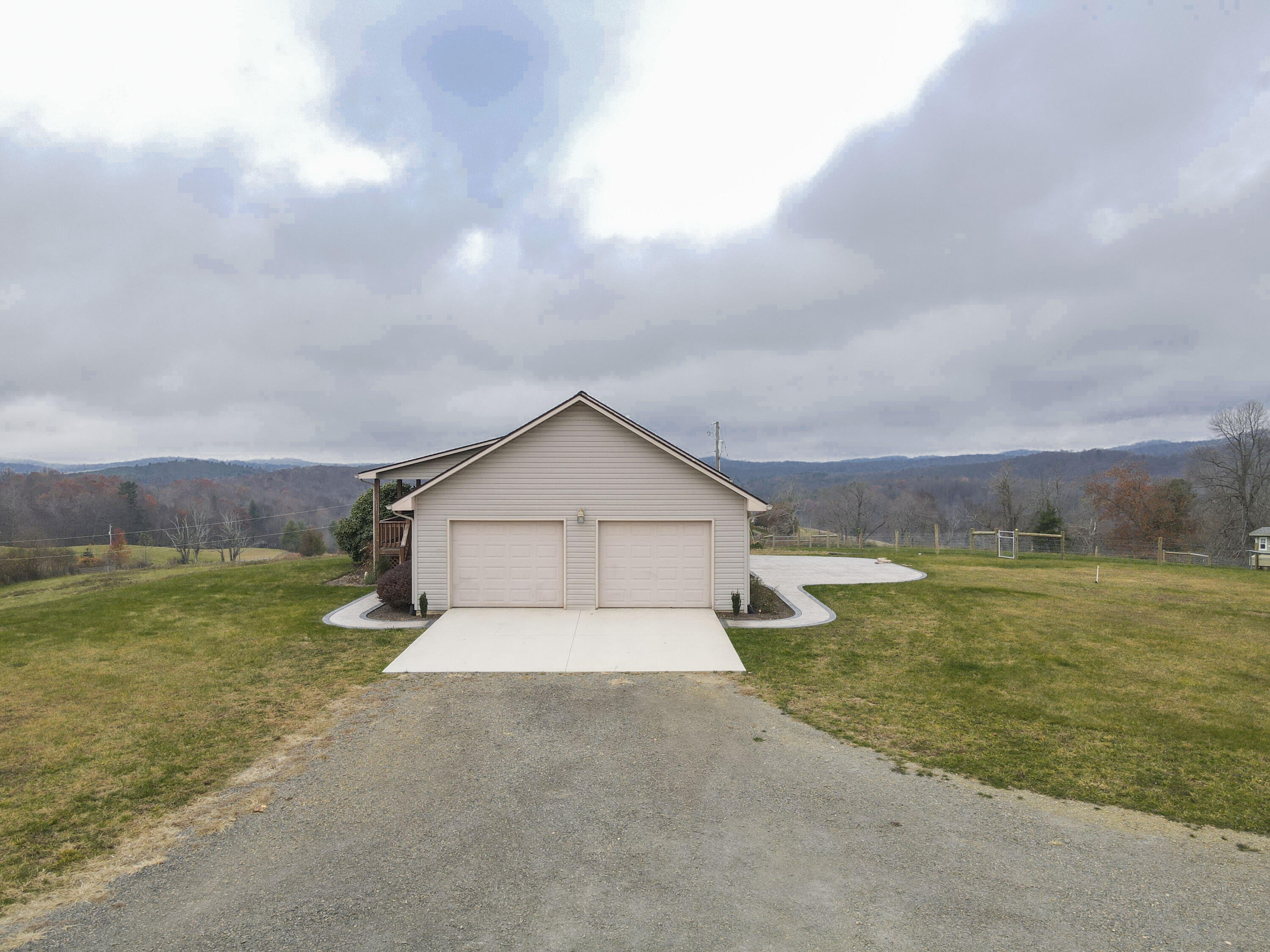 5485 Buffalo Mountain Road Southwest Willis, VA 24380 - Photo 17 of 77 a view of a house with a big yard and a large tree