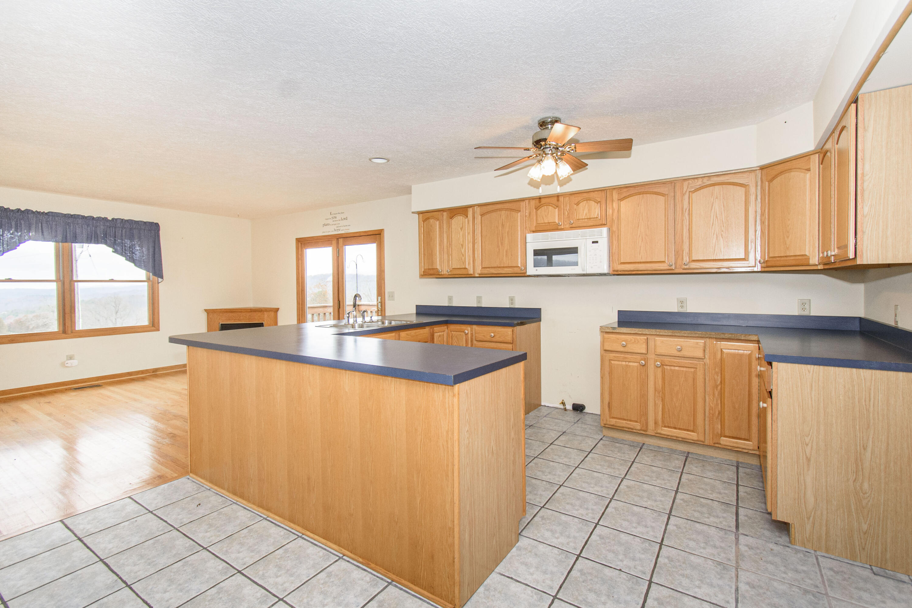 5485 Buffalo Mountain Road Southwest Willis, VA 24380 - Photo 23 of 77 a kitchen with stainless steel appliances granite countertop a stove a sink and a microwave