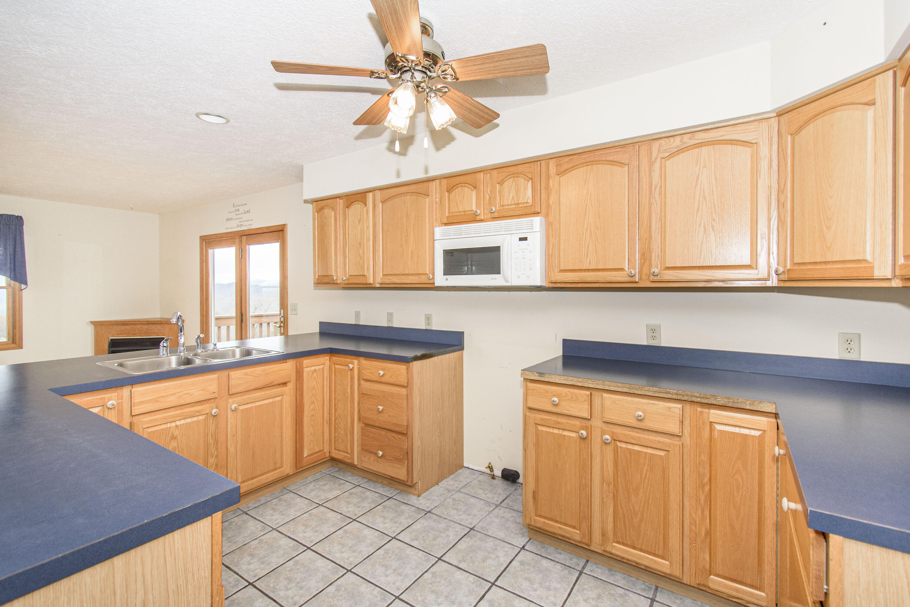 5485 Buffalo Mountain Road Southwest Willis, VA 24380 - Photo 24 of 77 a kitchen with granite countertop white cabinets and white appliances