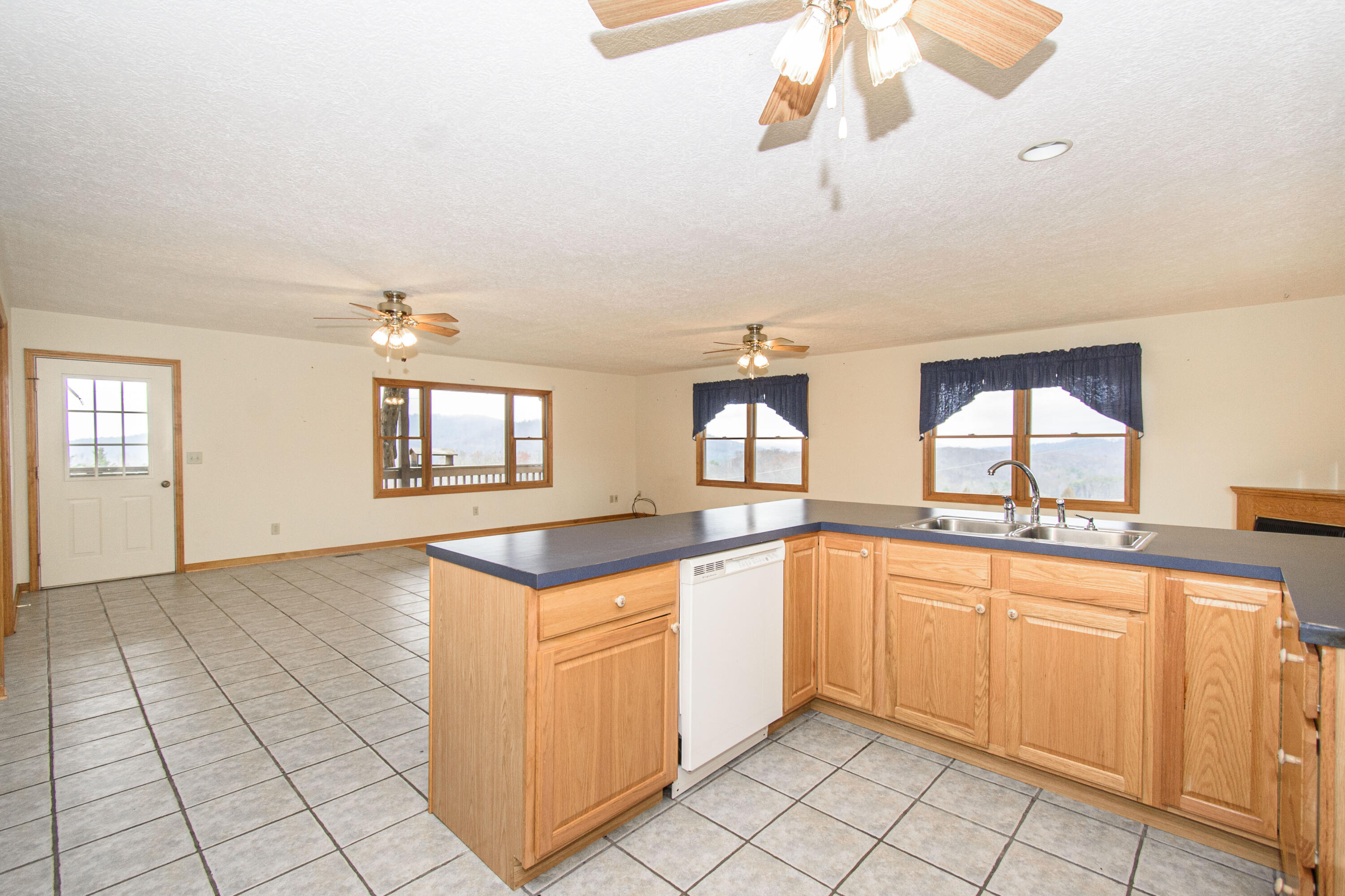 5485 Buffalo Mountain Road Southwest Willis, VA 24380 - Photo 25 of 77 a kitchen with a sink cabinets and window