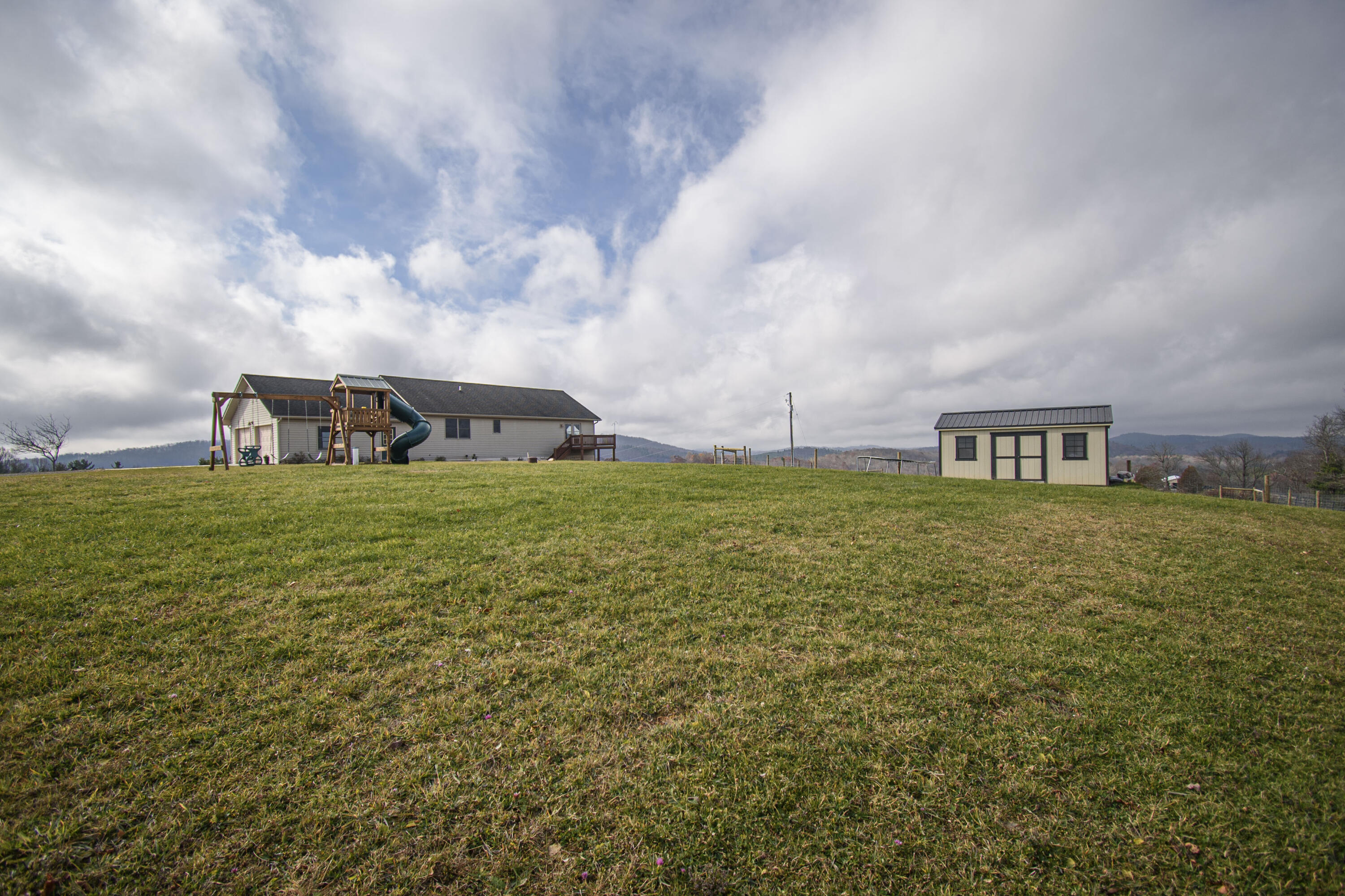 5485 Buffalo Mountain Road Southwest Willis, VA 24380 - Photo 60 of 77 a view of a big room with table and chairs next to a yard