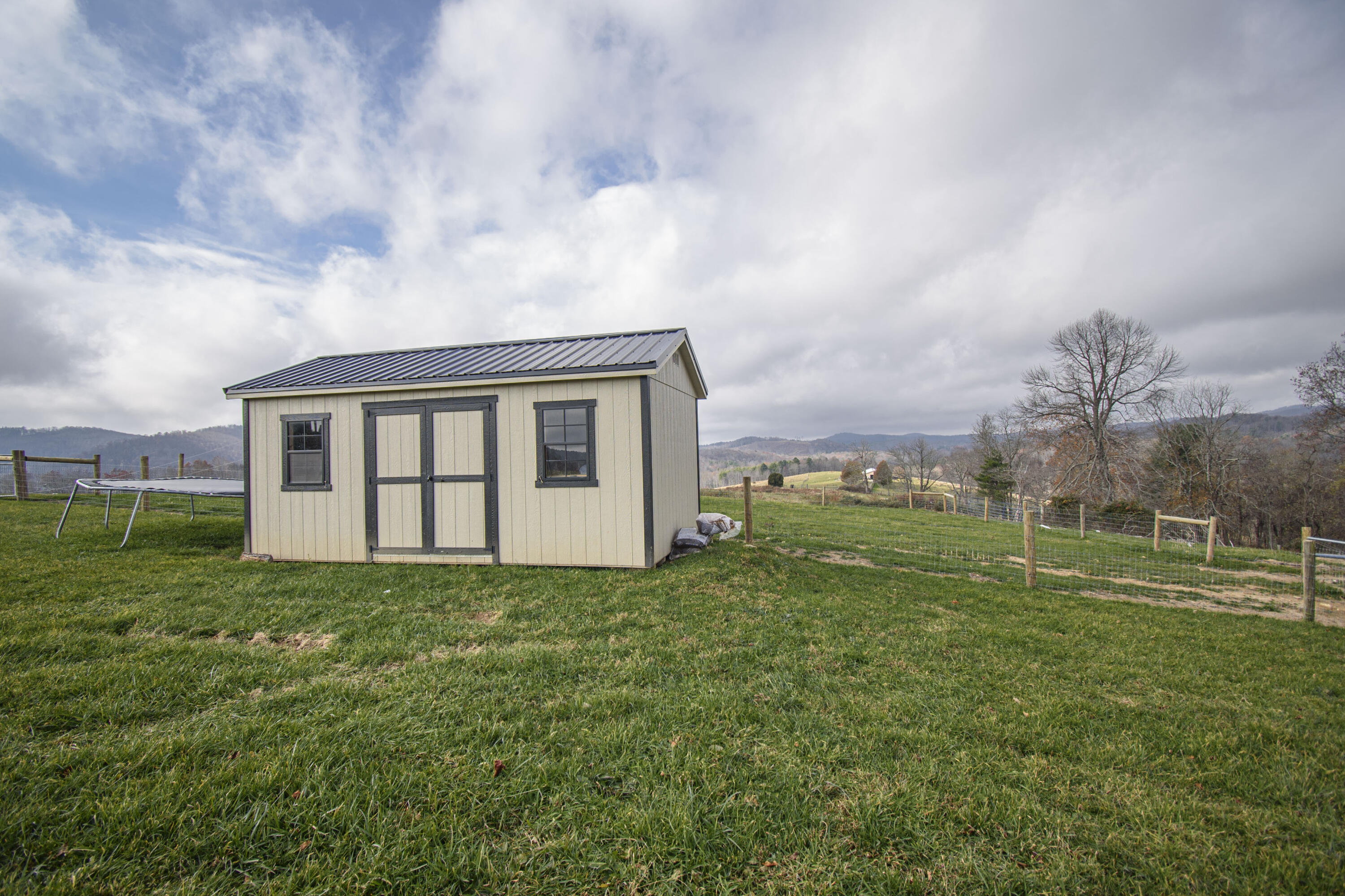 5485 Buffalo Mountain Road Southwest Willis, VA 24380 - Photo 62 of 77 a view of a house with a big yard and large trees