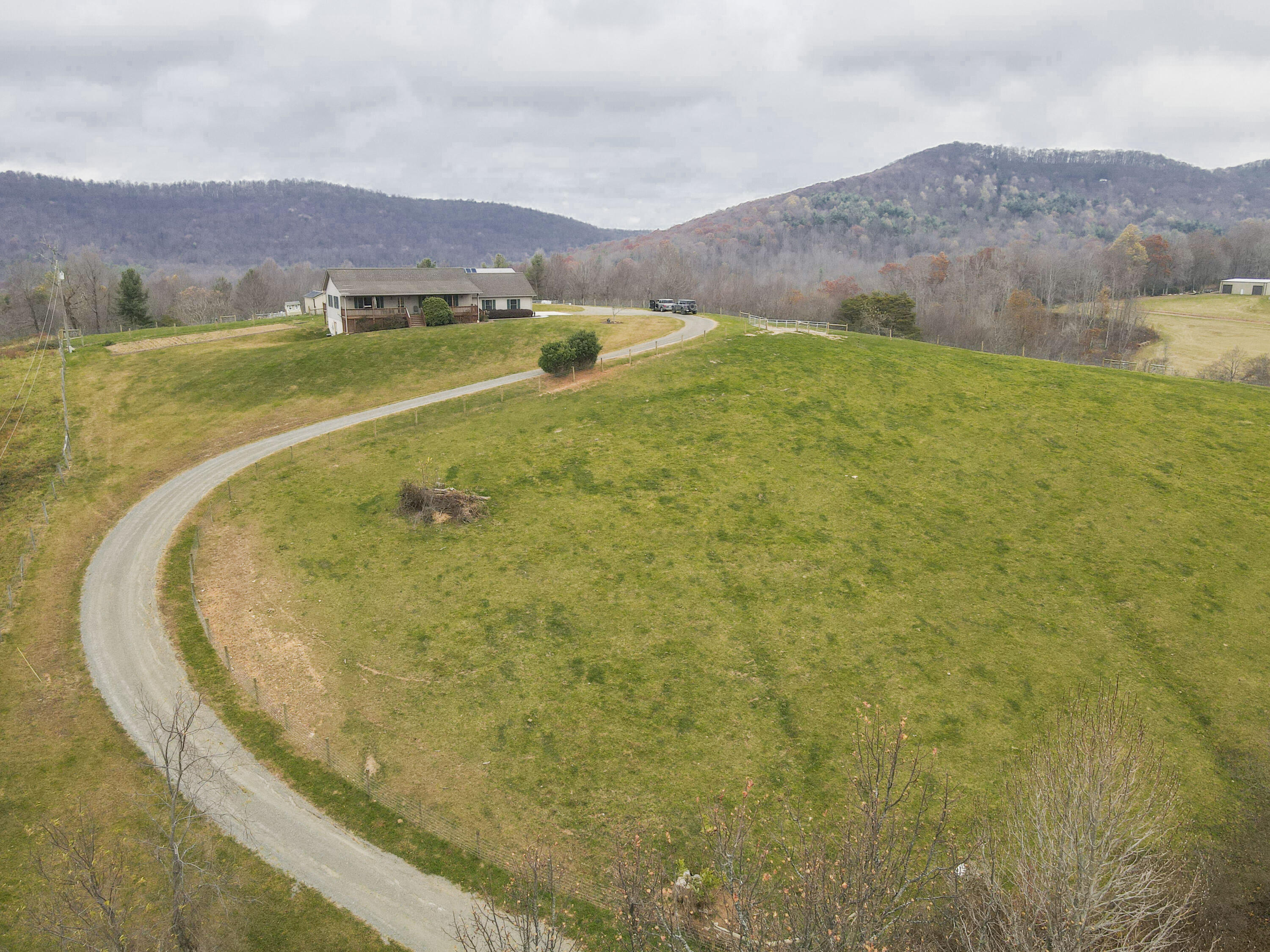 5485 Buffalo Mountain Road Southwest Willis, VA 24380 - Photo 65 of 77 a view of an aerial view of residential houses with outdoor space and mountain view