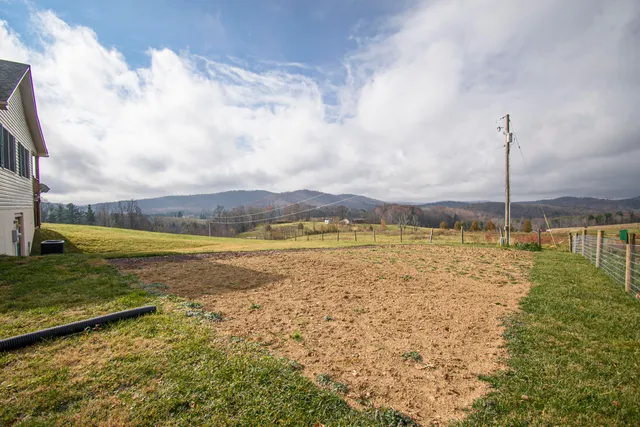 a view of a house with backyard and lake view