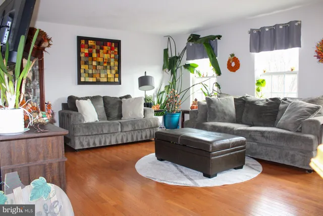 a living room with furniture and a painting on the wall