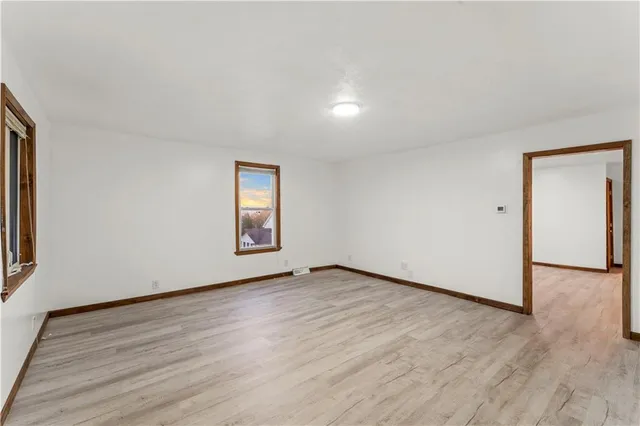 a large kitchen with stainless steel appliances a large counter top a stove and a refrigerator