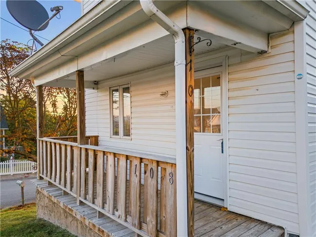 a view of a porch with wooden floor