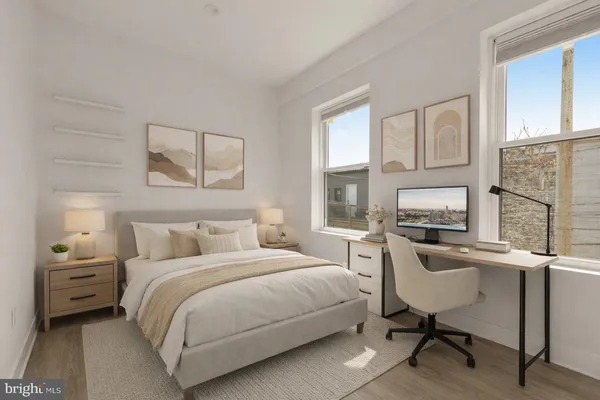 a bedroom with a bed a table and chair