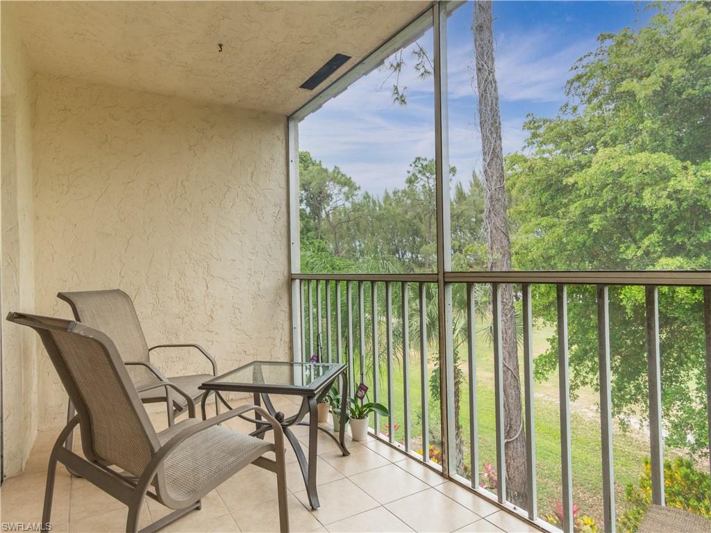 499 Forest Lakes Boulevard, Unit 2309 Naples, FL 34105 - Photo 11 of 29 a view of a chairs and table in the balcony