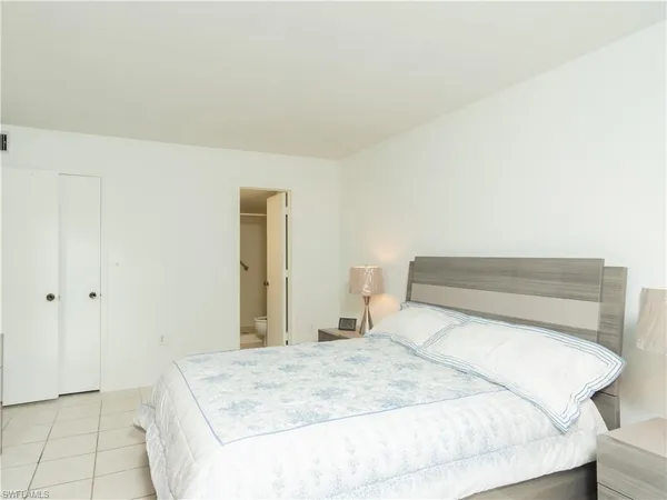 a bedroom with a bed and a mirror