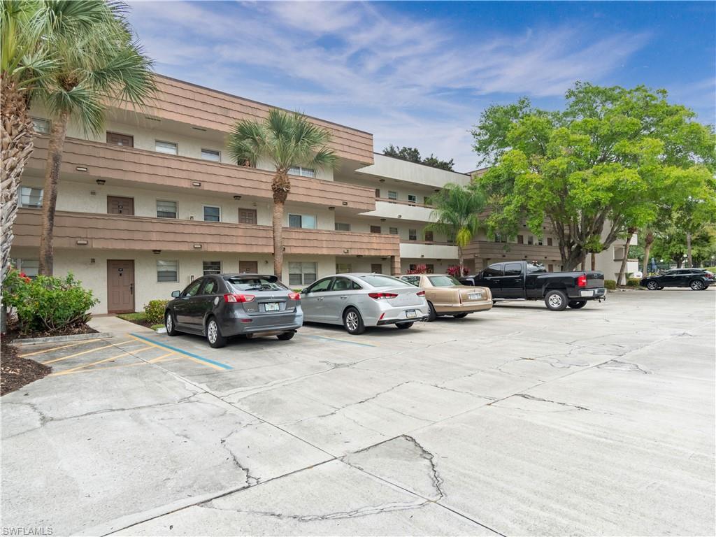 499 Forest Lakes Boulevard, Unit 2309 Naples, FL 34105 - Photo 20 of 29 a view of a cars parked in front of a building