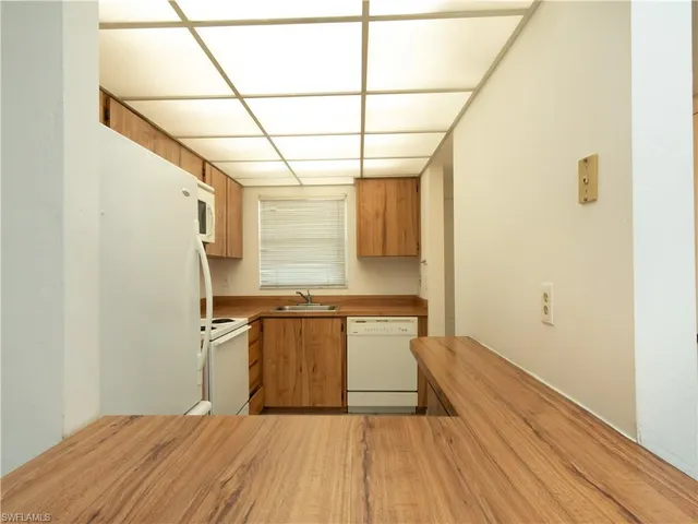 a view of a kitchen with wooden floor