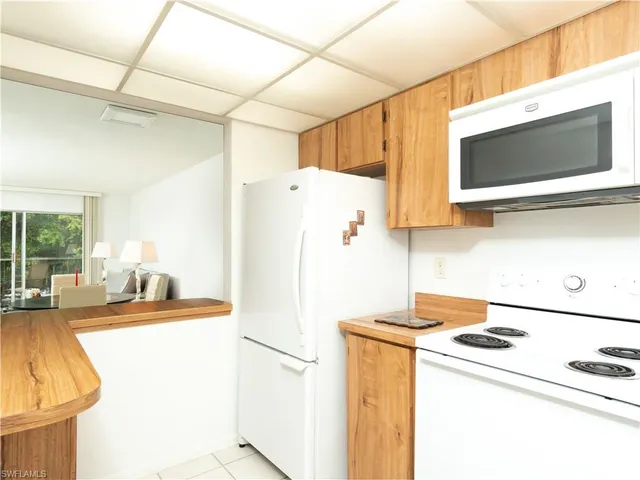 a kitchen with a refrigerator sink stove and microwave