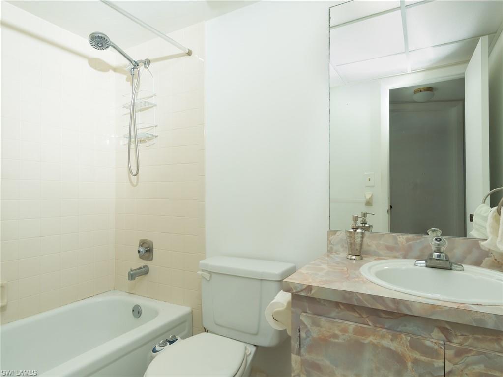 499 Forest Lakes Boulevard, Unit 2309 Naples, FL 34105 - Photo 28 of 29 a bathroom with a sink toilet and shower