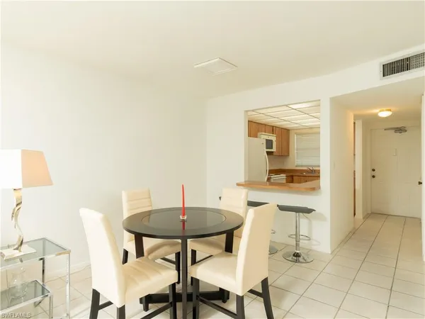 a view of a dining room with furniture and a potted plant
