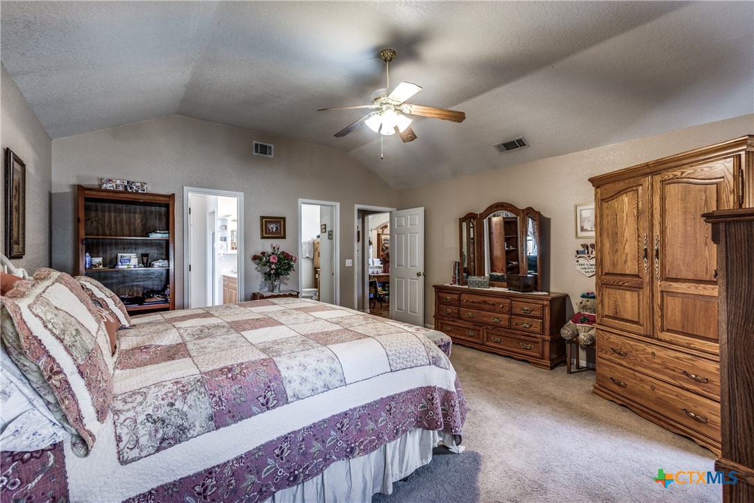1408 County Road 3300 Kempner, TX 76539 - Photo 14 of 25 a bedroom with a large bed a flat tv screen and dresser