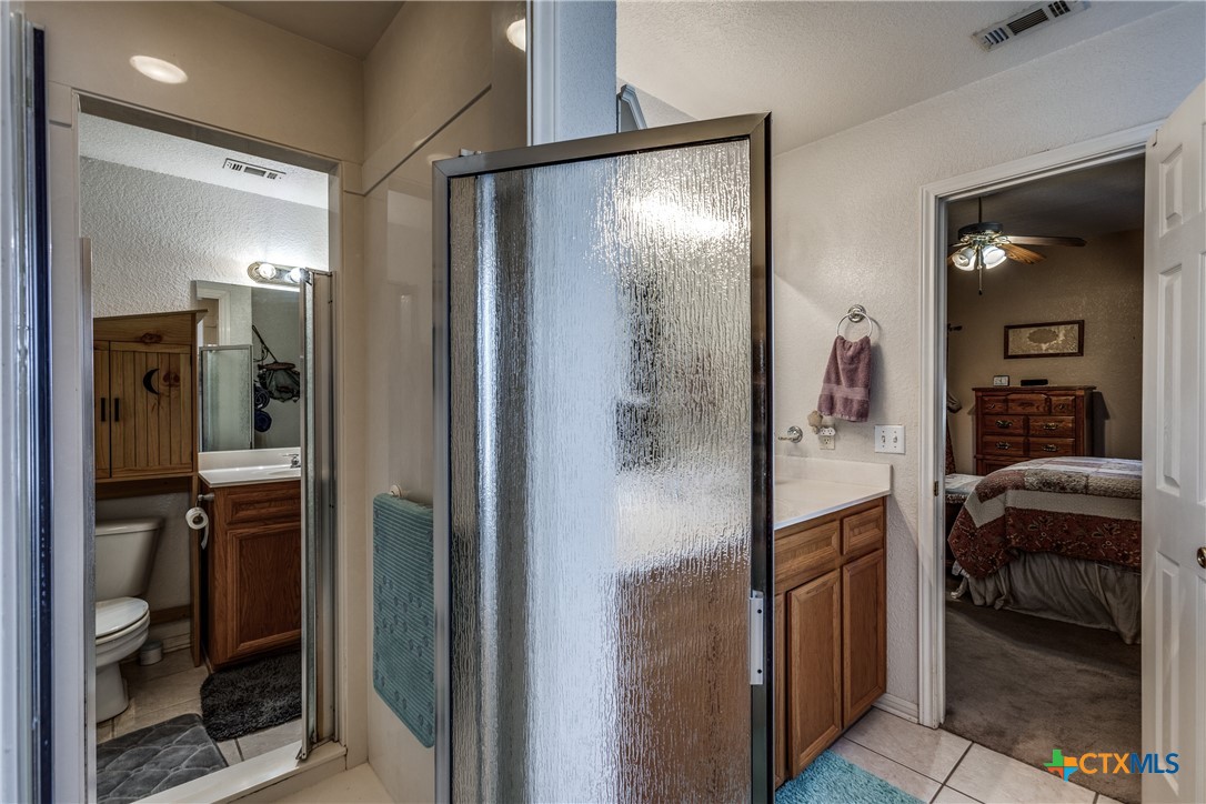 1408 County Road 3300 Kempner, TX 76539 - Photo 16 of 25 a en suite bathroom with a shower a mirror and a sink