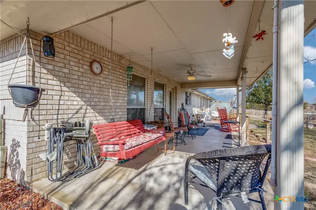 a view of a patio with a table and chairs under an umbrella