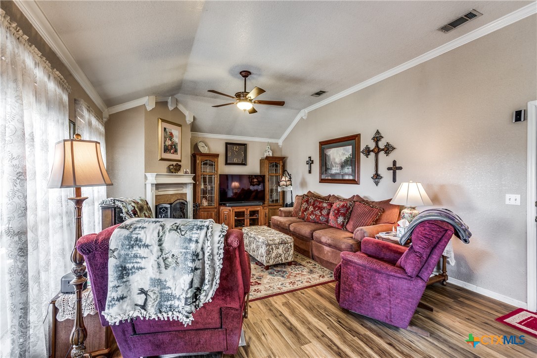 1408 County Road 3300 Kempner, TX 76539 - Photo 5 of 25 a living room with furniture a fireplace and a chandelier