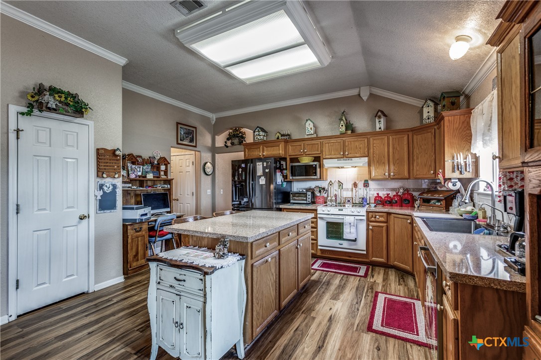 1408 County Road 3300 Kempner, TX 76539 - Photo 8 of 25 a kitchen with a stove and a refrigerator