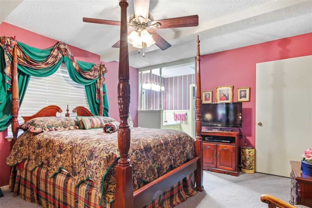 14202 Valleyview Ridge Tyler, TX 75709 - Photo 12 of 29 a bedroom with a bed and dresser with mirror