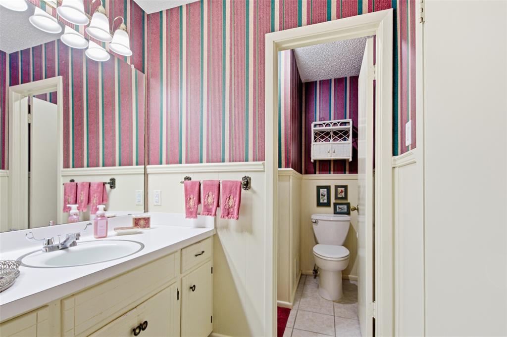 14202 Valleyview Ridge Tyler, TX 75709 - Photo 13 of 29 a bathroom with a sink vanity mirror and toilet