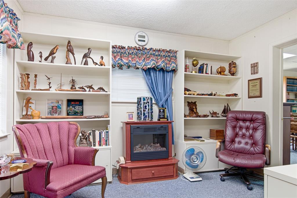 14202 Valleyview Ridge Tyler, TX 75709 - Photo 24 of 29 a living room with furniture and a shelf
