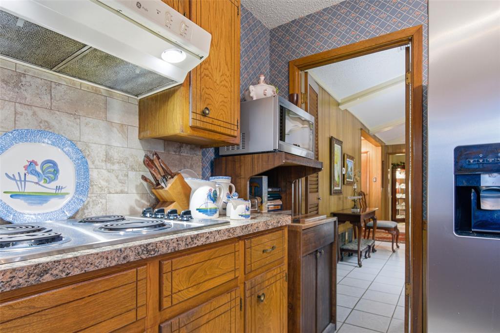 14202 Valleyview Ridge Tyler, TX 75709 - Photo 8 of 29 a kitchen with a sink and a wooden cabinets