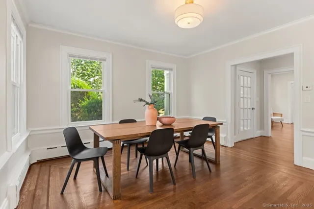 a view of a dining room with furniture window and wooden floor