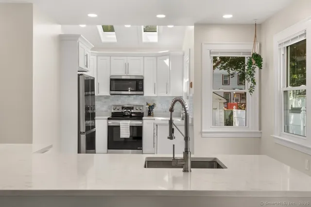 a kitchen with a refrigerator and a stove top oven