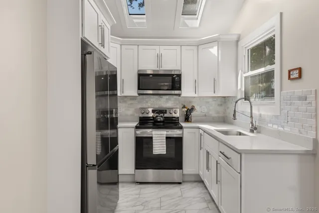 a kitchen with a sink stove and microwave