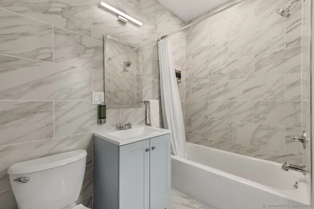 a bathroom with a sink a toilet and a bathtub