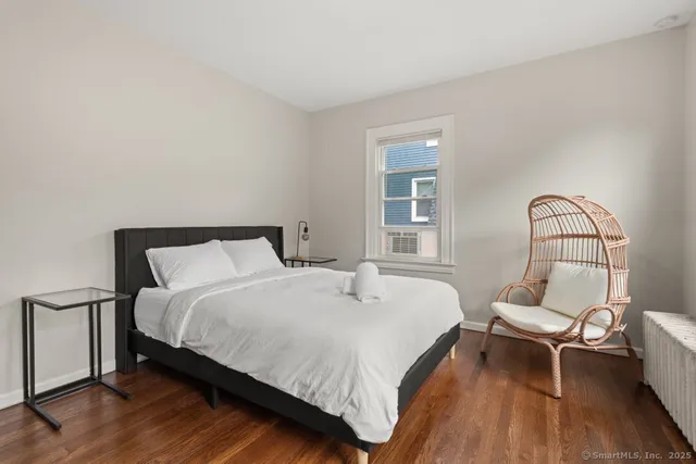 a bed room with a bed and a chair