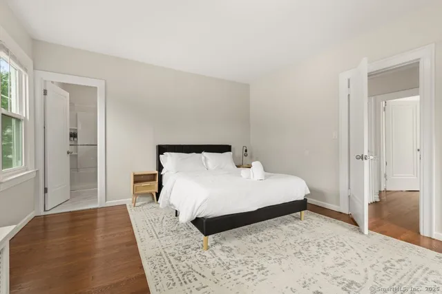 a bedroom with a bed and wooden floor