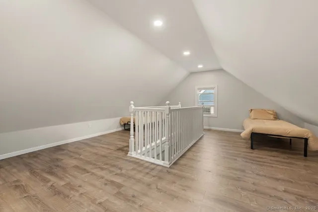 a view of a livingroom with wooden floor and a ceiling fan