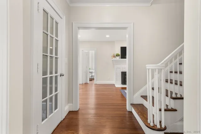 a view of a livingroom with wooden floor and entryway