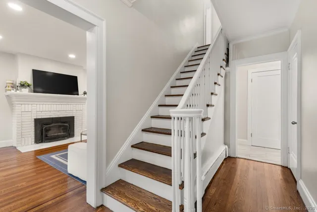 a view of a livingroom with wooden floor and white walls