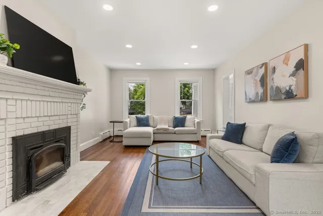 a living room with furniture and a fireplace