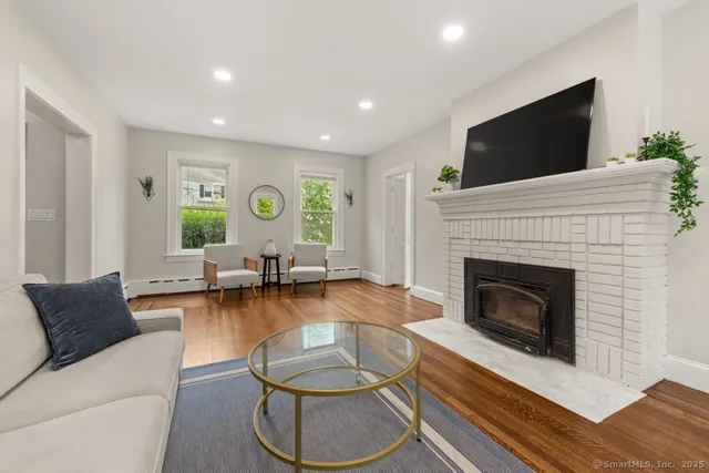 a living room with furniture and a fireplace
