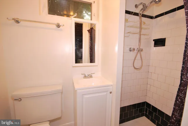 a bathroom with a shower and a sink